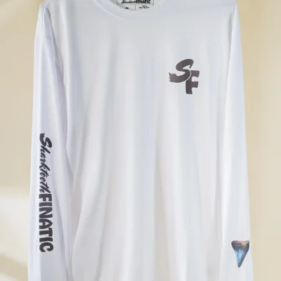 white performance long-sleeve shirt with black logo and koi pond great white shark tooth design on the sleeve